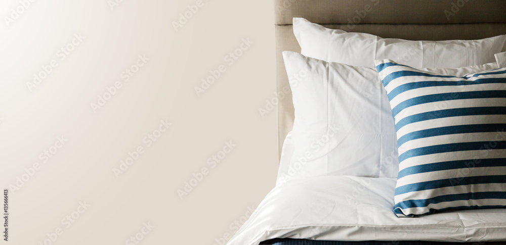 Bed maid-up with clean white pillows and bed sheets in beauty ro