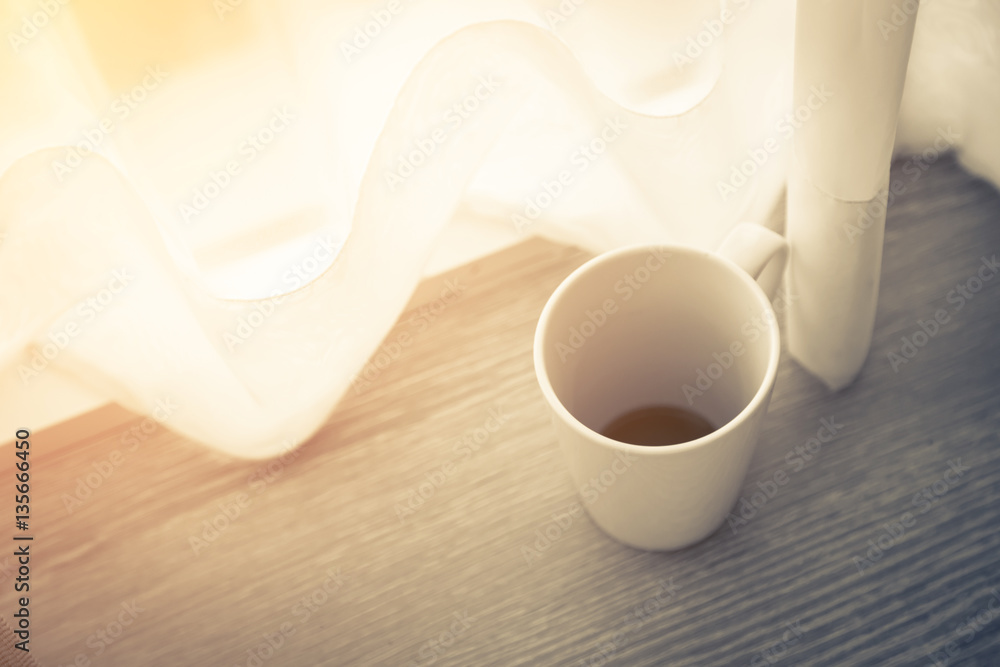 morning white cup coffee with white curtain near window with sun