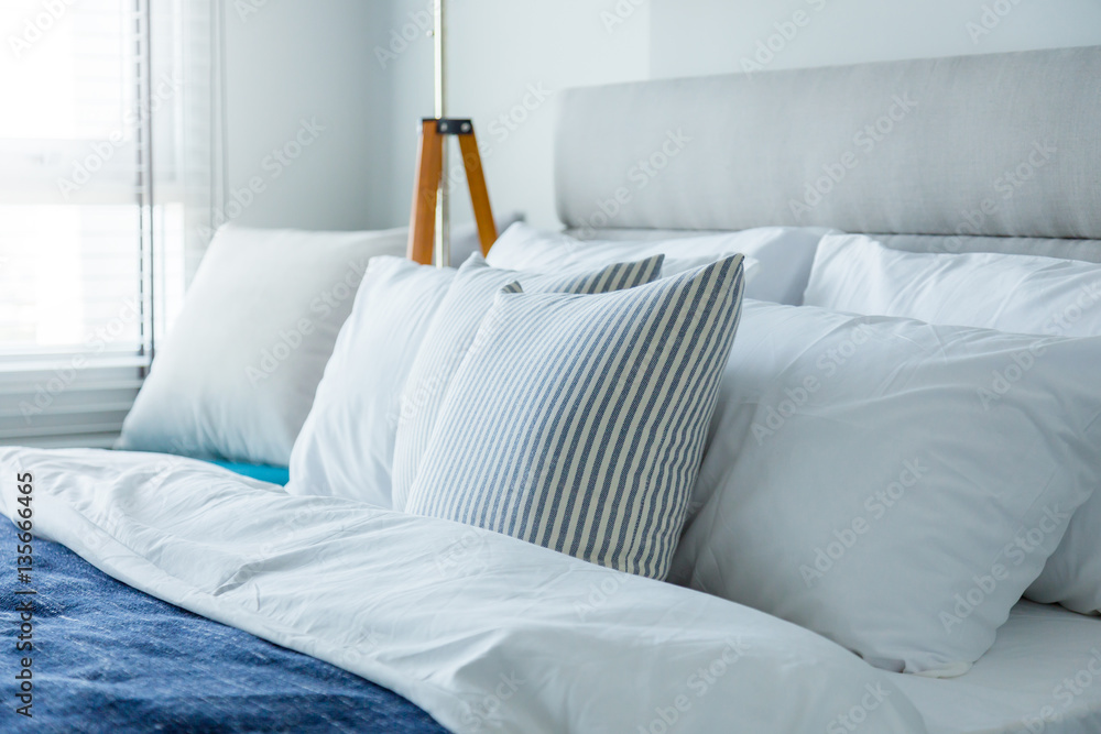 Bed maid-up with clean white pillows and bed sheets in beauty ro