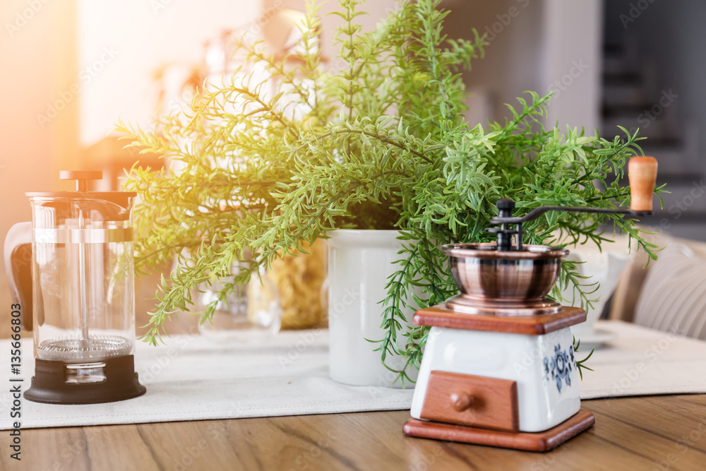 set of tea or coffee with small teapot on wooden table with room