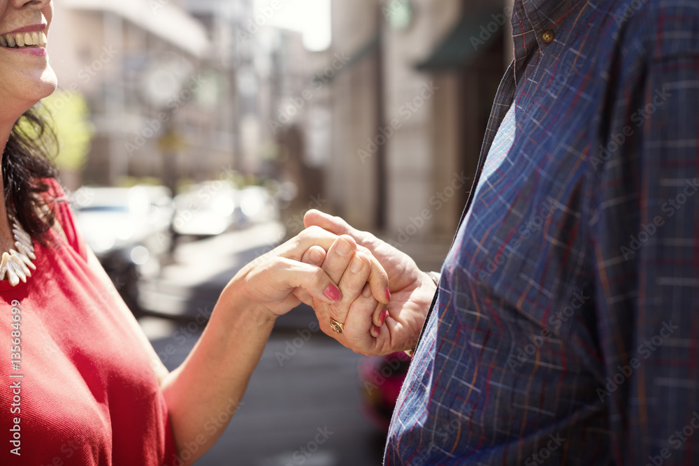 Senior couple holding hands together