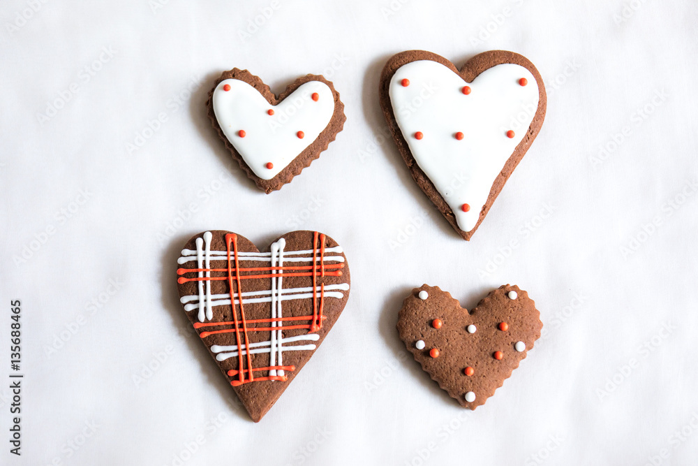 Heart shaped chocolate Valentines Day cookies with red and white glaze.