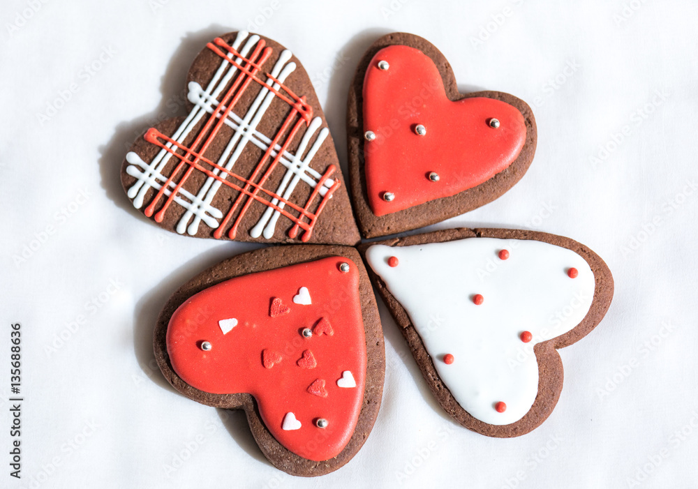 Heart shaped chocolate Valentines Day cookies with red and white glaze.