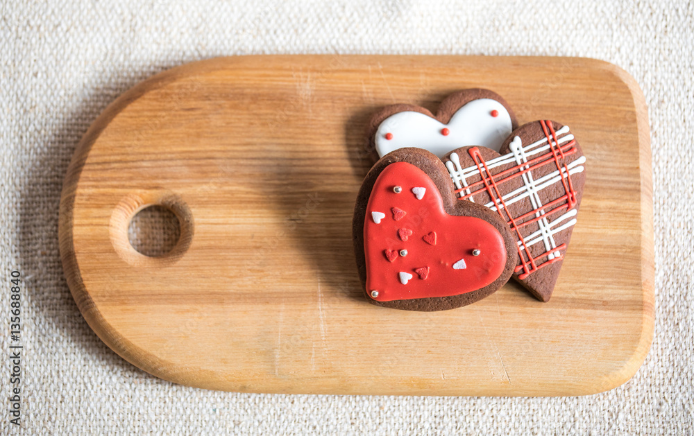 Heart shaped chocolate Valentines Day cookies with red and white glaze.