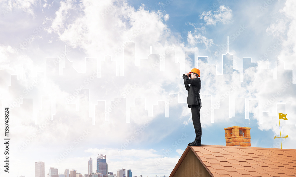 Engineer man standing on roof and looking in binoculars. Mixed media