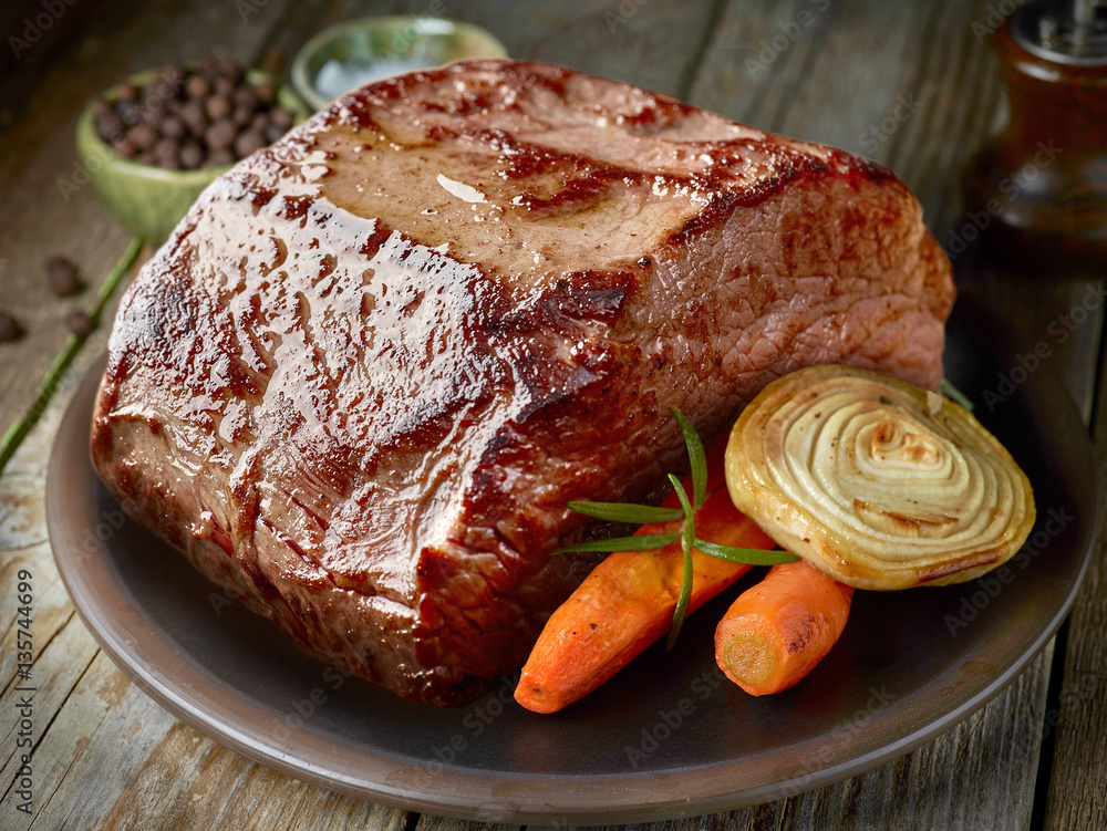 roasted deer on dark plate