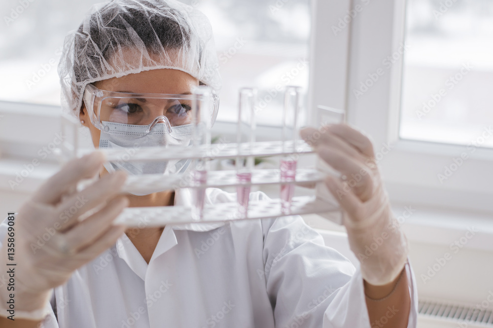 Female medical or scientific researcher using test tube on labor