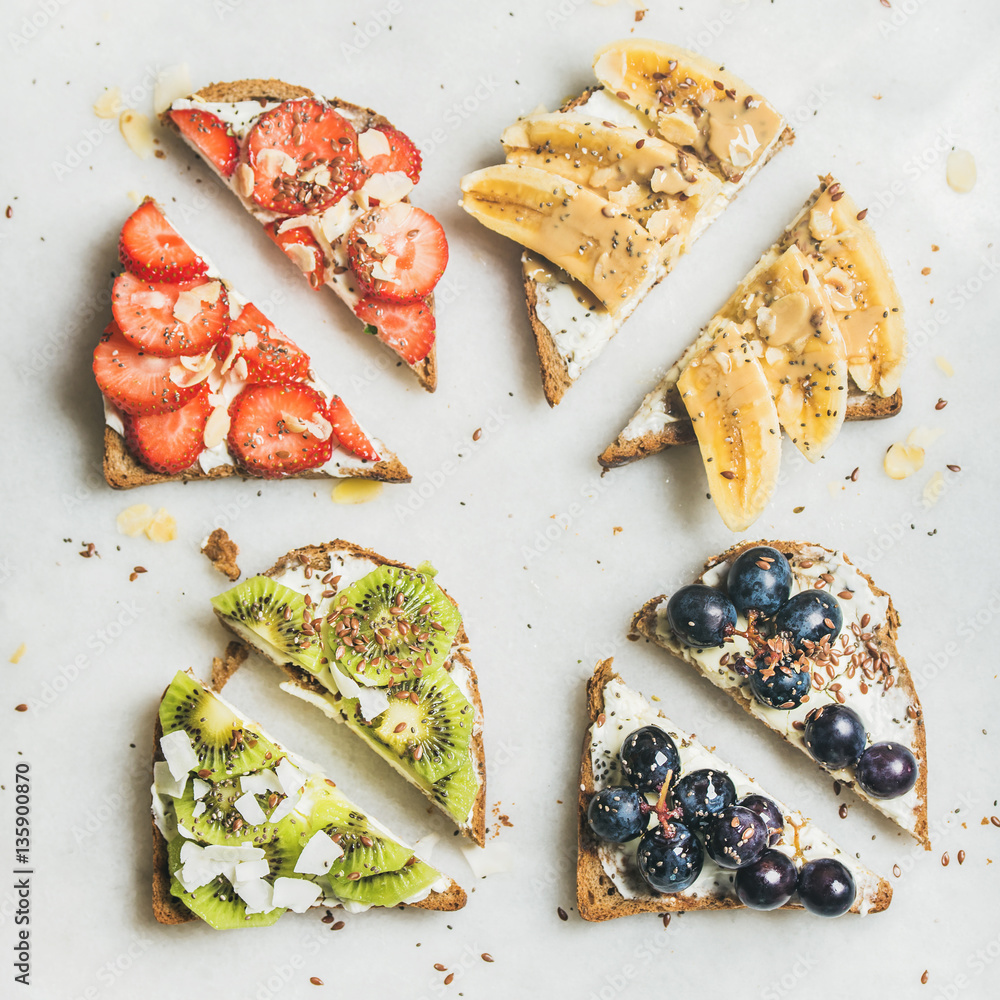 Healthy breakfast toasts cut in pieces. Wholegrain bread slices with cream cheese, various fruit, se