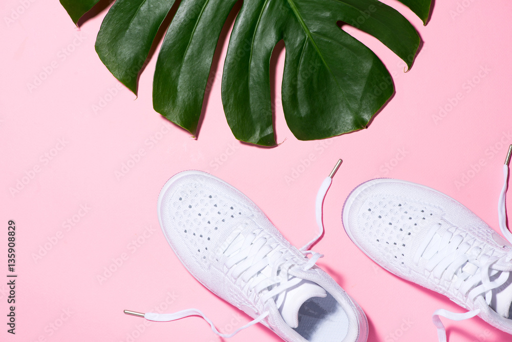 Sport concept. Sneakers on light pink background.