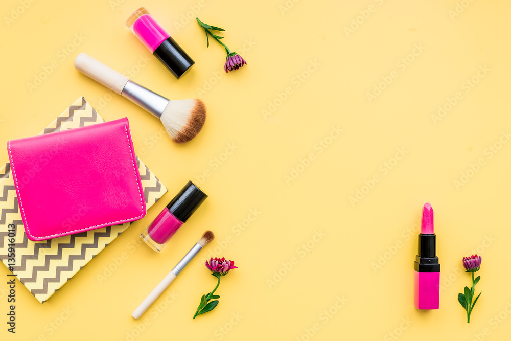 decorative cosmetics on yellow background top view