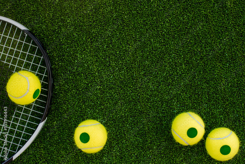 tennis racket on green background top view