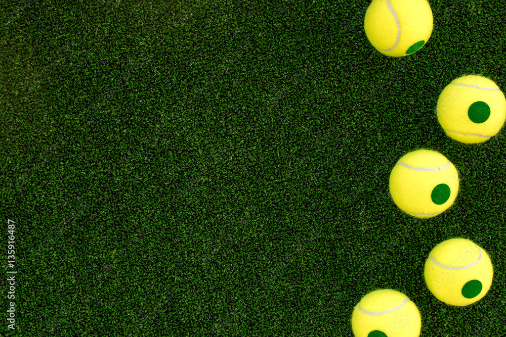 tennis racket on green background top view