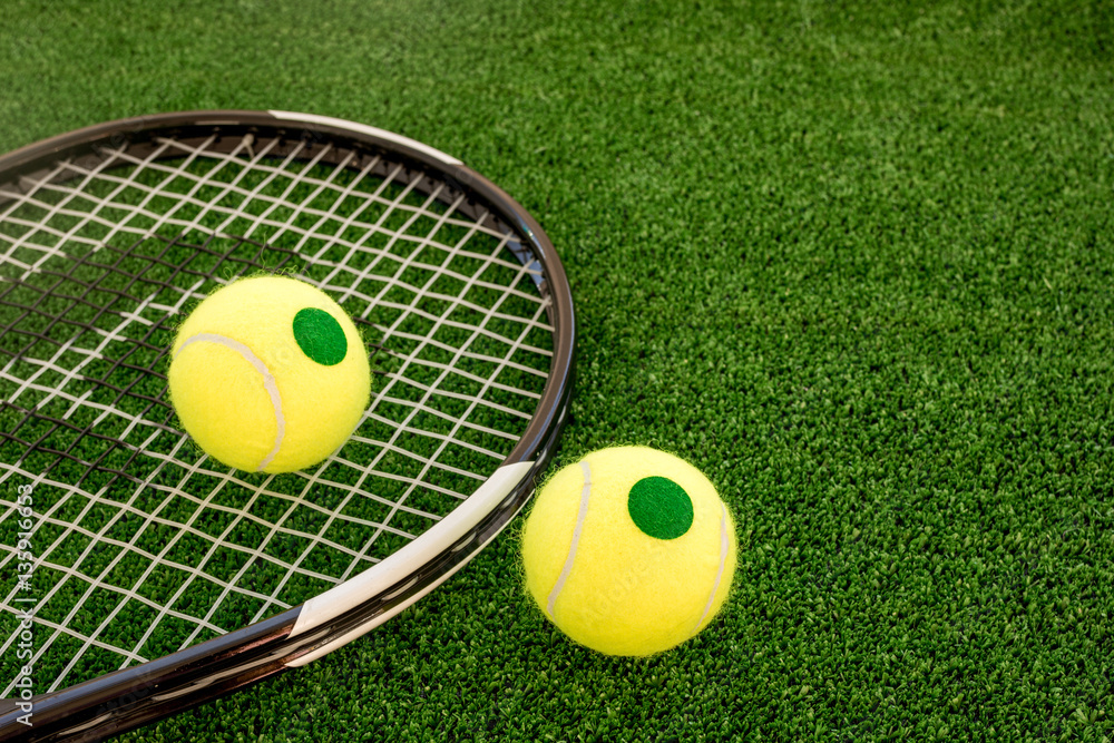 tennis racket on green background