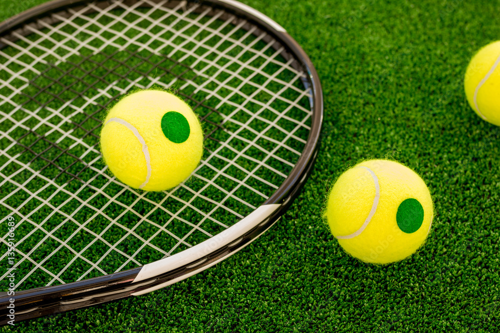 tennis racket on green background