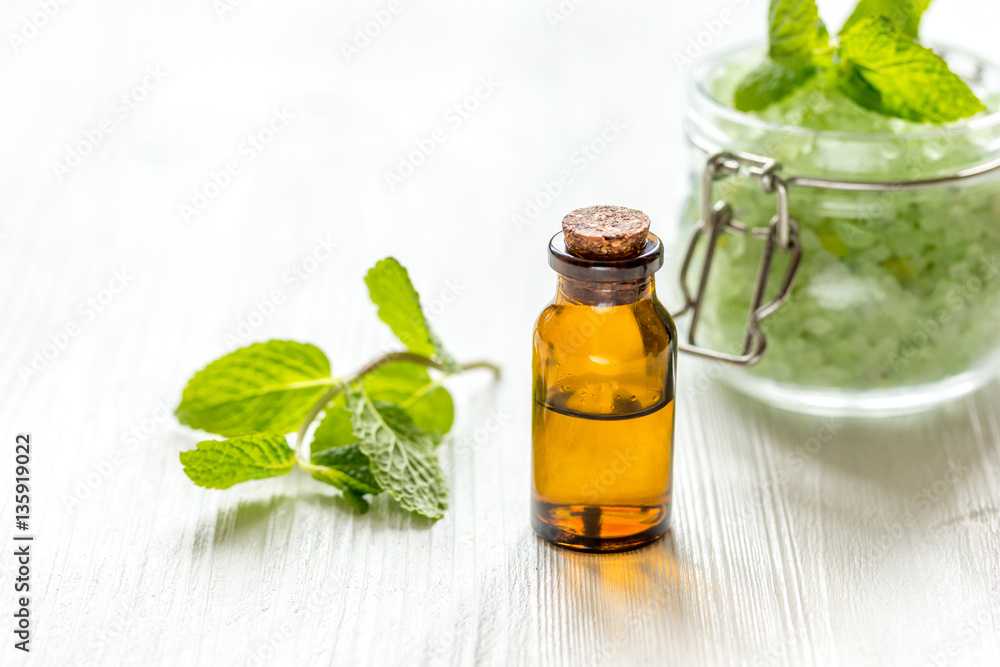 organic cosmetics with herbal extracts of mint on wooden background