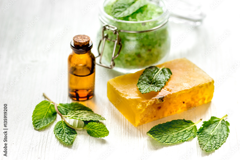 organic cosmetics with herbal extracts of mint on wooden background