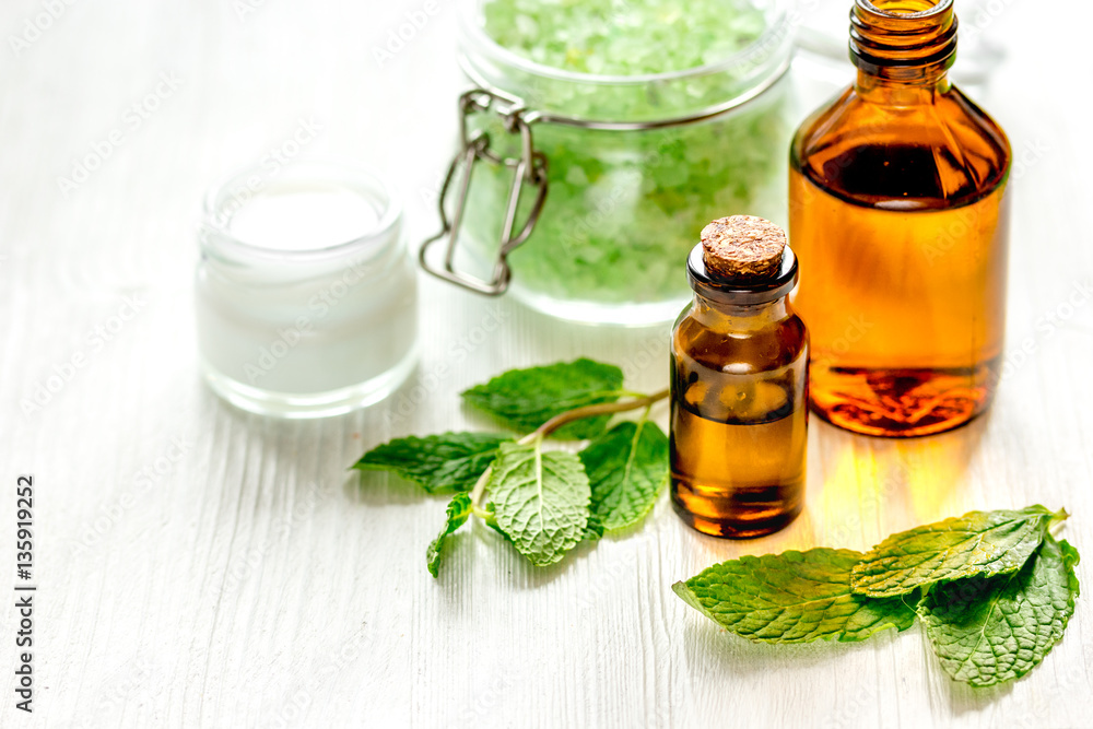 organic cosmetics with herbal extracts of mint on wooden background