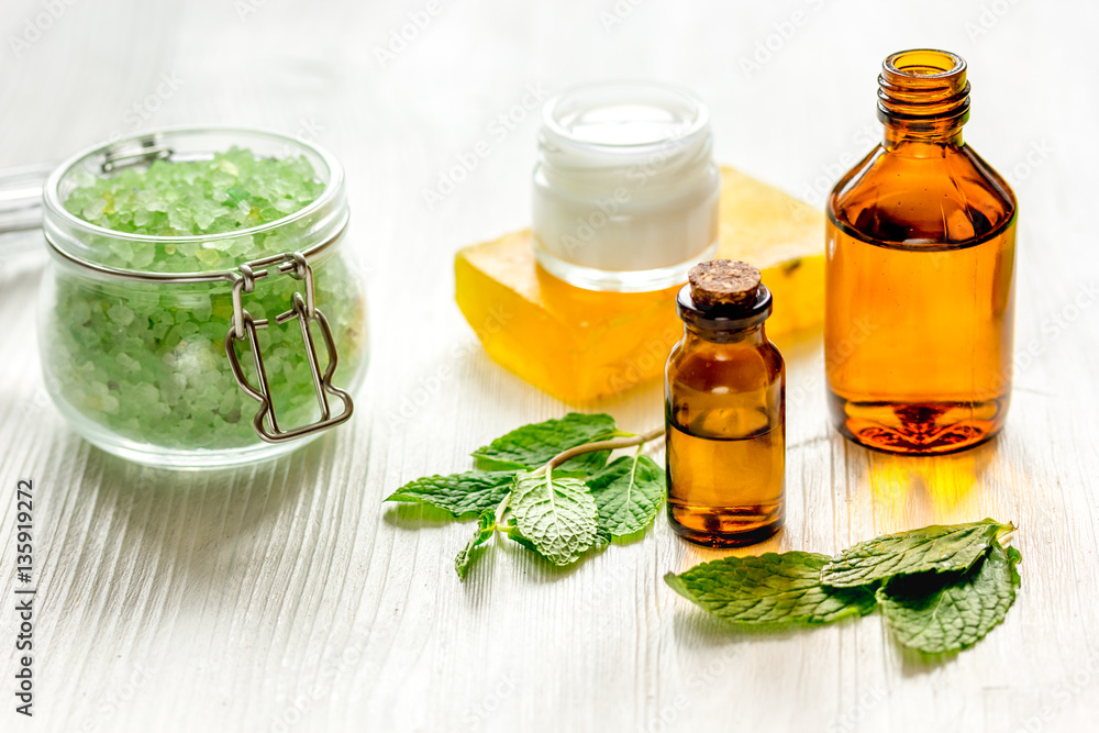 organic cosmetics with herbal extracts of mint on wooden background