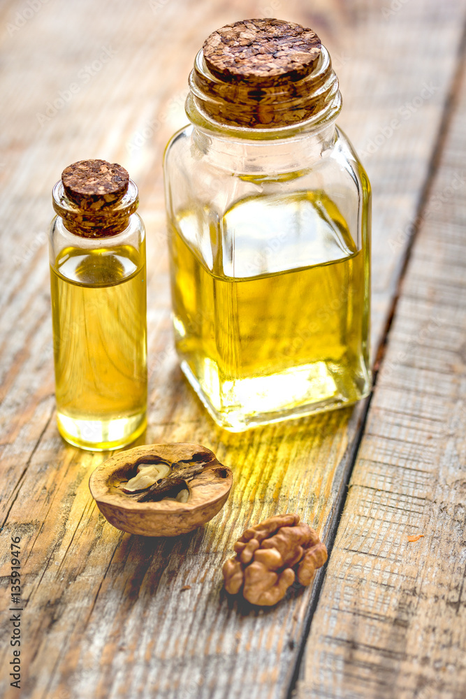 cosmetic and therapeutic walnut oil on wooden background