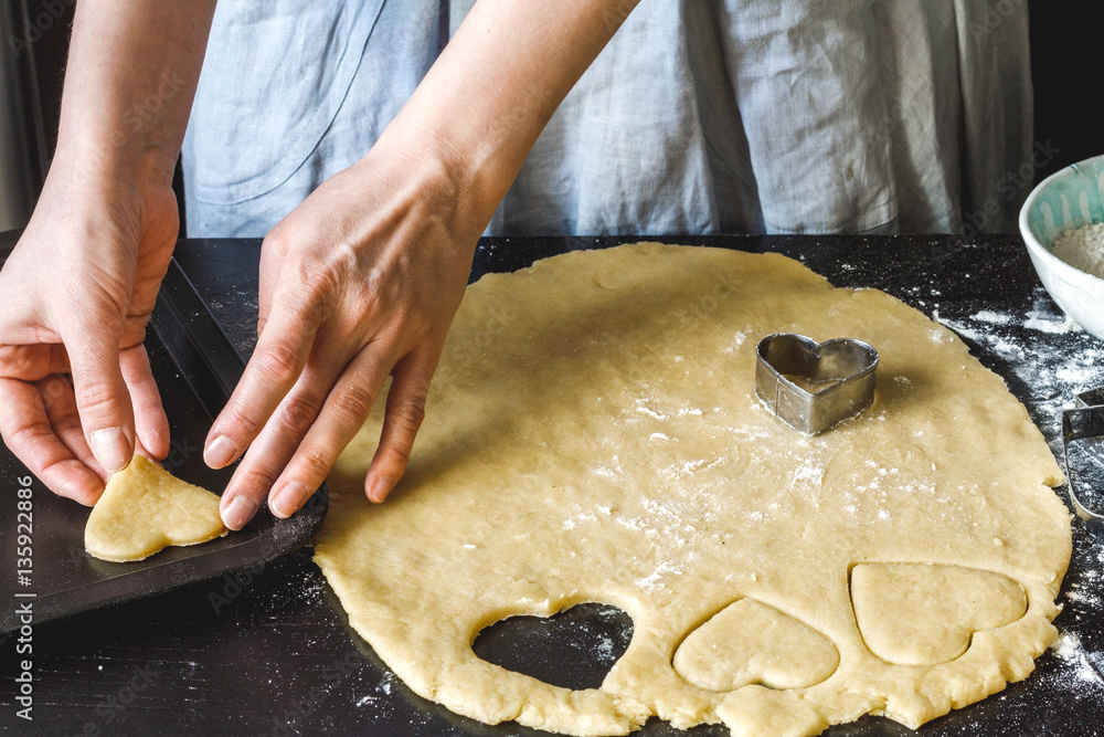 cooking homemade cookies with hands on dark background