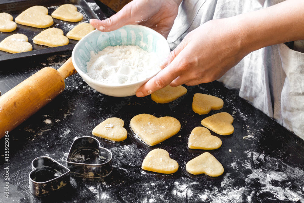 cooking homemade cookies with hands on dark background