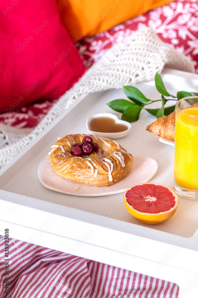 concept of breakfast in bed on tray with juice