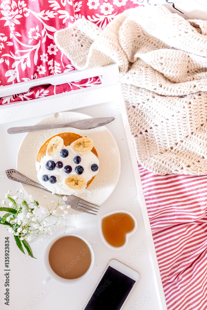 concept of breakfast in bed on tray with juice