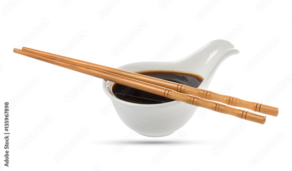 Soy sauce and chopsticks isolated on white