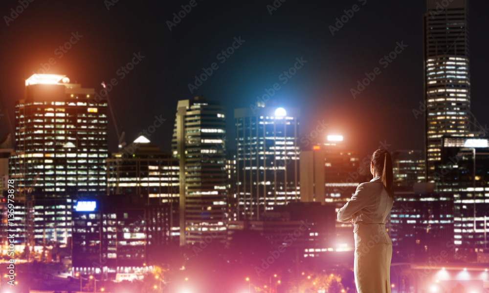 Woman looking at night city