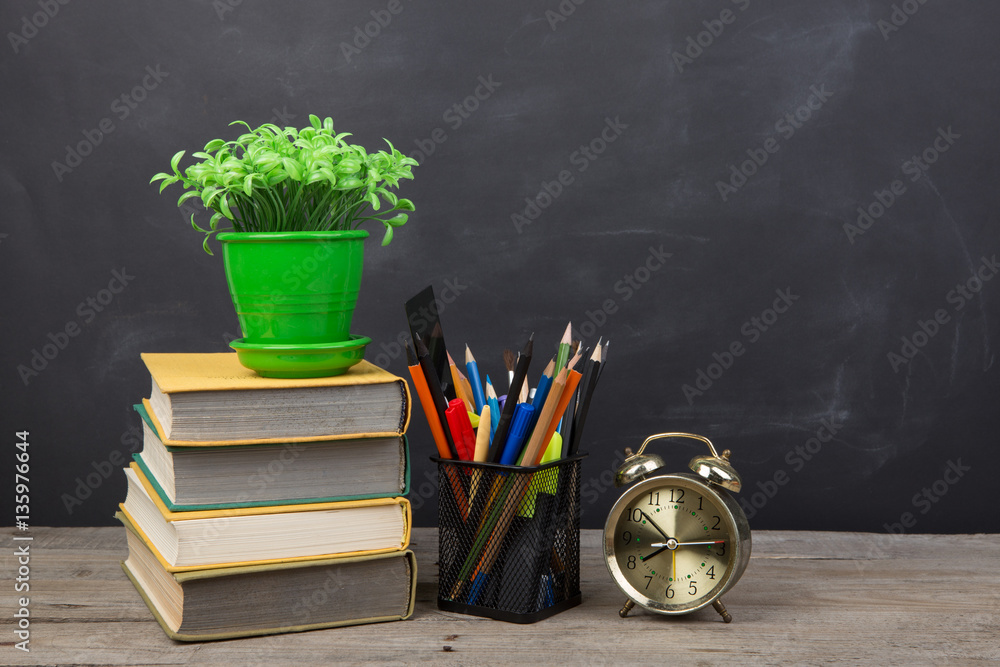 Education concept - books on the desk in the auditorium