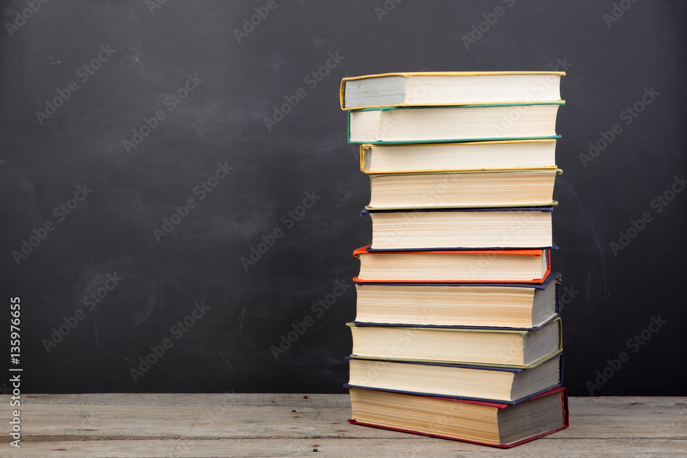 Education concept - books on the desk in the auditorium