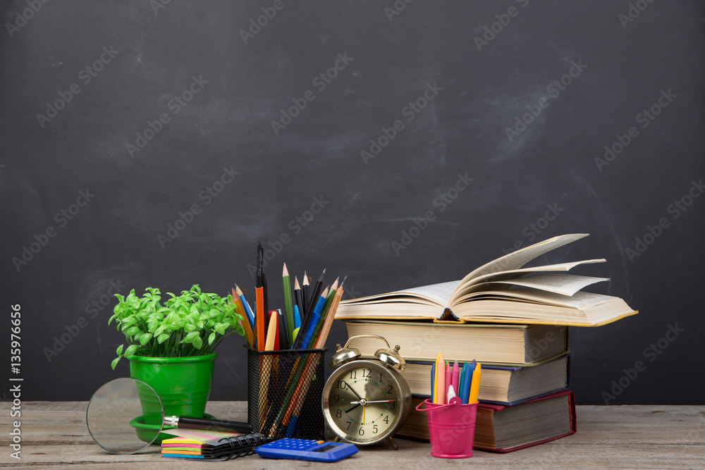 Education concept - books on the desk in the auditorium