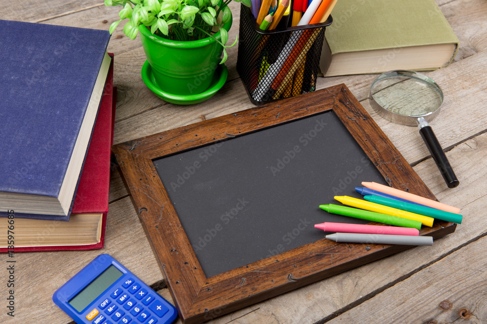 school supplies and blackboard with copy space on table