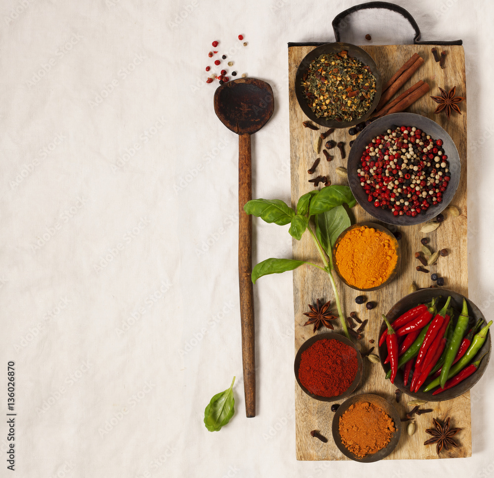 Different spices in bowls on table