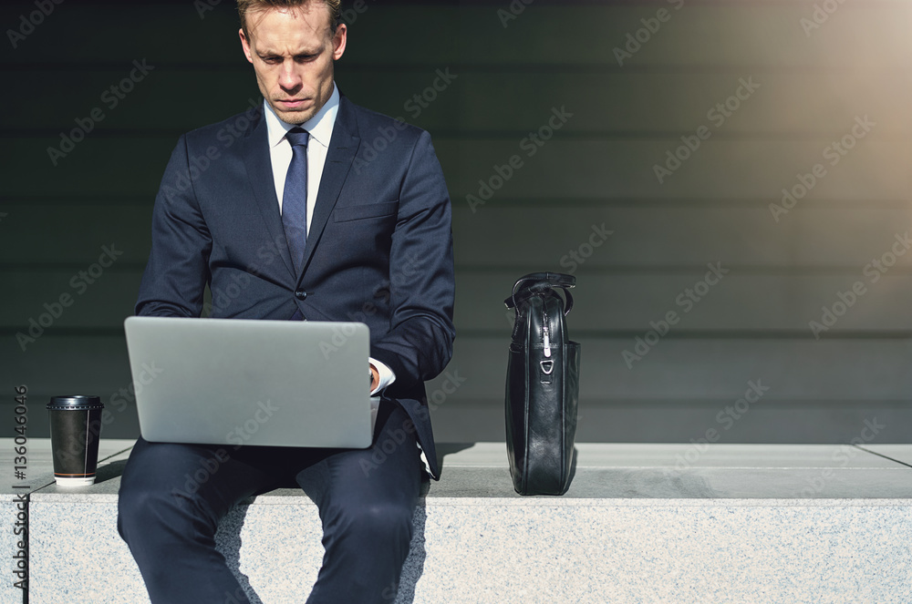 Confident businessman while work with his laptop