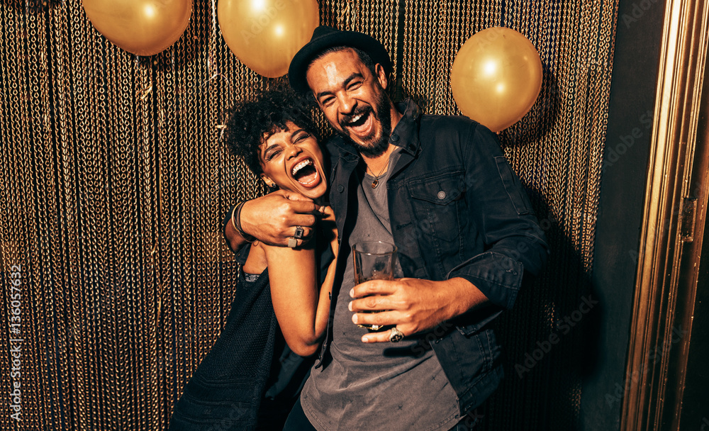 Happy young couple having fun at disco