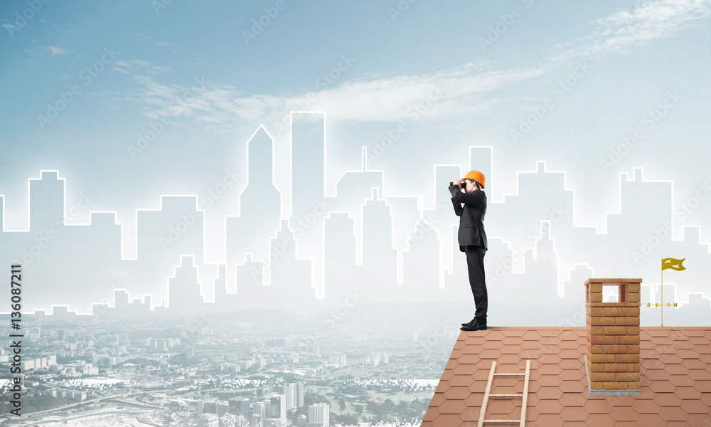 Engineer man standing on roof and looking in binoculars. Mixed media