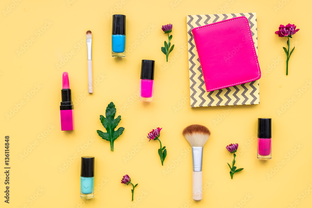 decorative cosmetics on yellow background top view