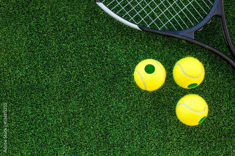 tennis racket on green background top view