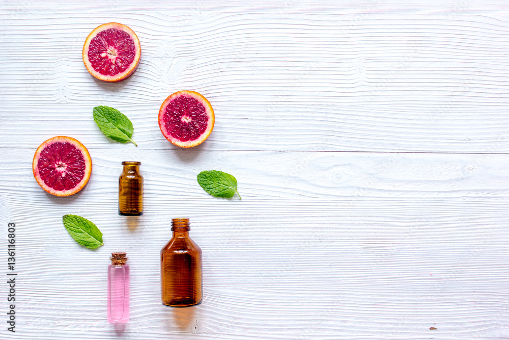 organic cosmetic with citrus on wooden background top view