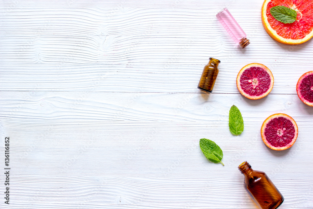 organic cosmetic with citrus on wooden background top view