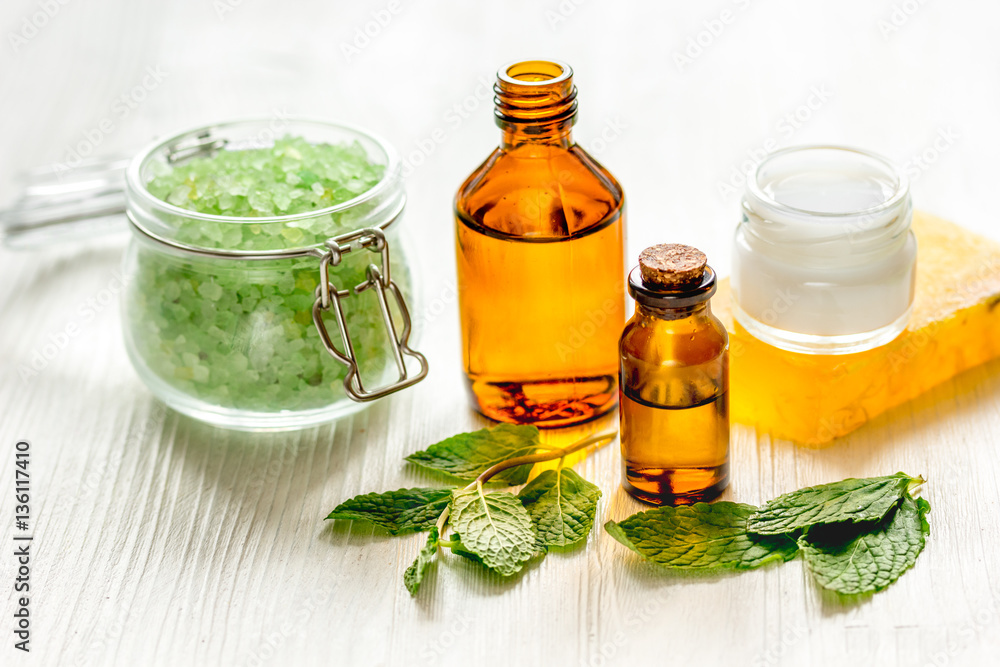 organic cosmetics with herbal extracts of mint on wooden background