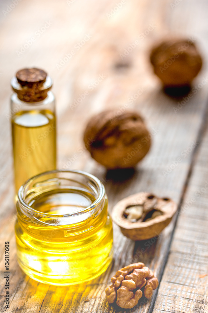 cosmetic and therapeutic walnut oil on wooden background