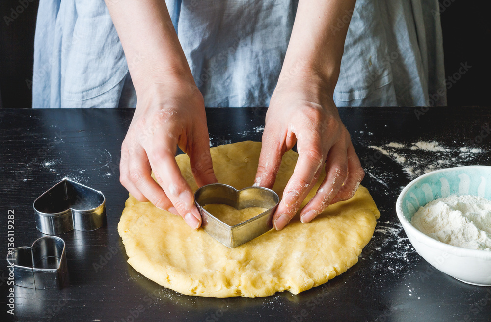 cooking homemade cookies with hands on dark background