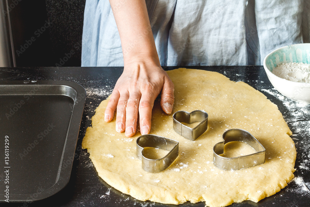 cooking homemade cookies with hands on dark background