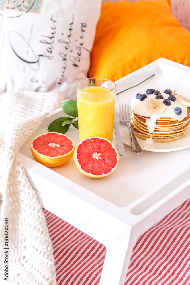 concept of breakfast in bed on tray with juice