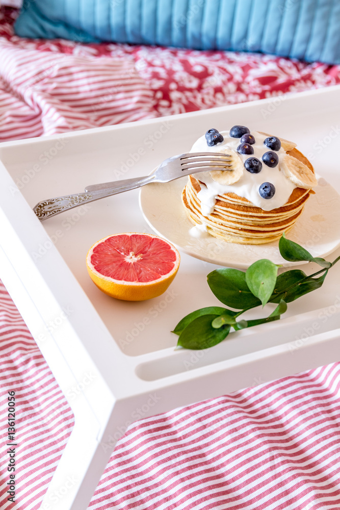 concept of breakfast in bed on tray with juice