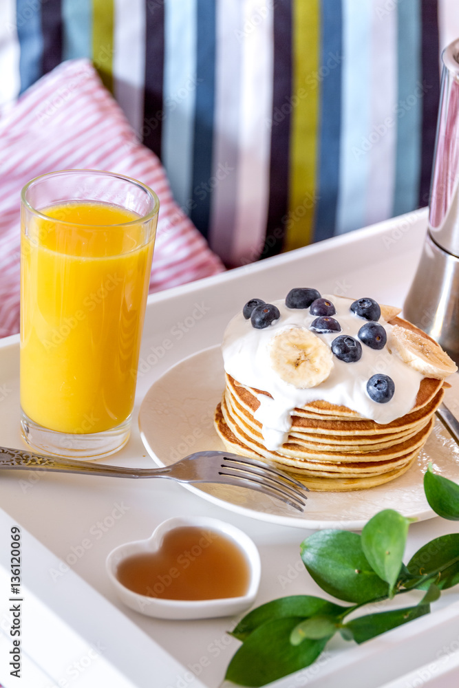 concept of breakfast in bed on tray with juice