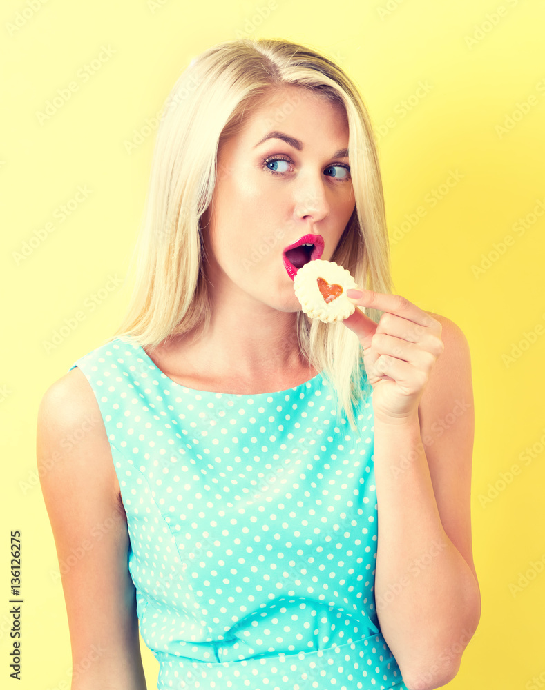 Happy young woman with cookie