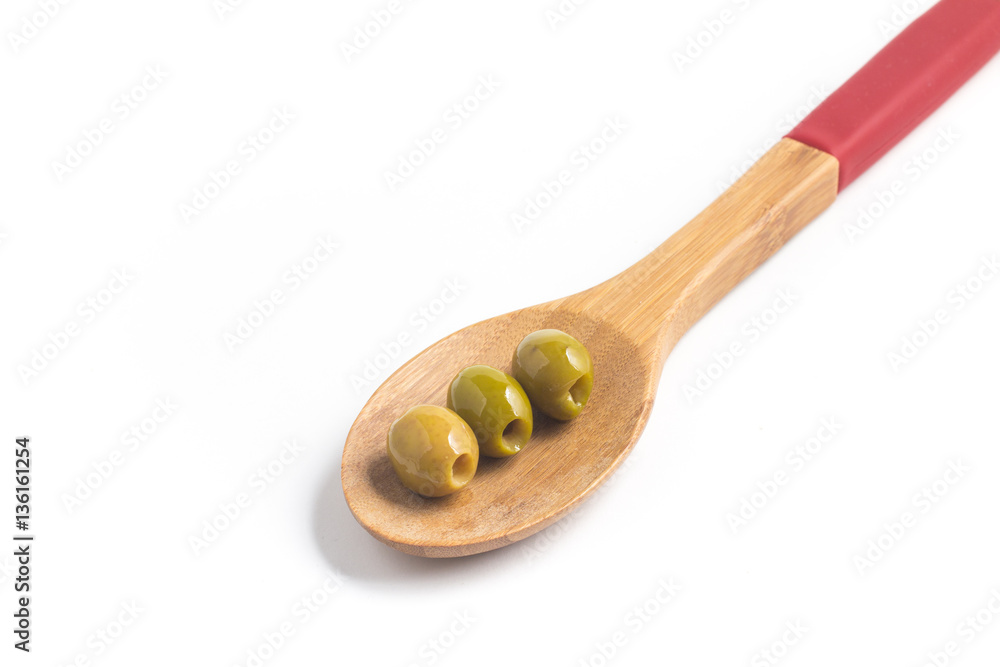 Green Olives into a spoon